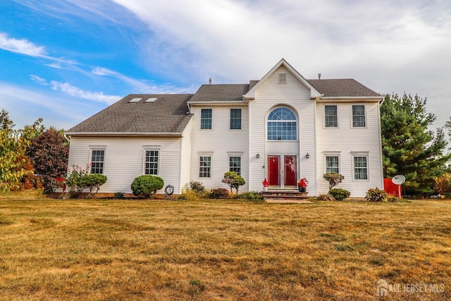 colonial-style house with a front lawn