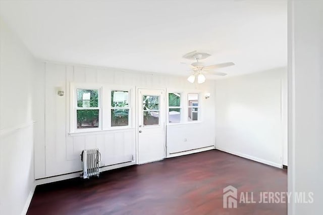 unfurnished room featuring a baseboard radiator, radiator heating unit, and a ceiling fan