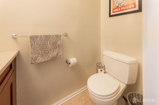 bathroom featuring tile patterned flooring, toilet, vanity, and baseboards