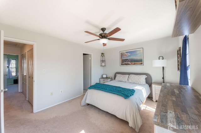 bedroom featuring a ceiling fan, baseboards, and light carpet