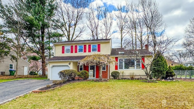 28 Livingston Ave, Edison, NJ 08820 - traditional home with asphalt driveway, an attached garage, and a chimney