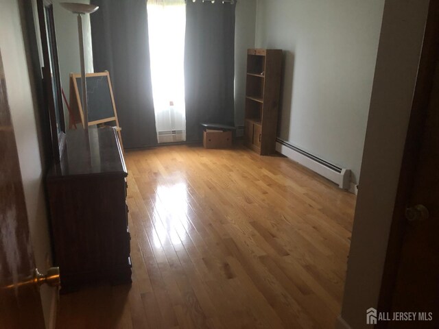 41 Bartha Ave, Edison, NJ 08817 - unfurnished room with baseboard heating, light wood-style floors, and plenty of natural light