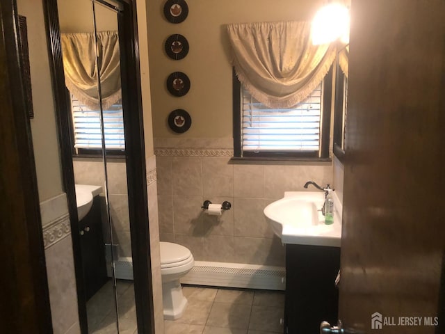 41 Bartha Ave, Edison, NJ 08817 - bathroom with vanity, tile patterned flooring, a baseboard radiator, toilet, and tile walls