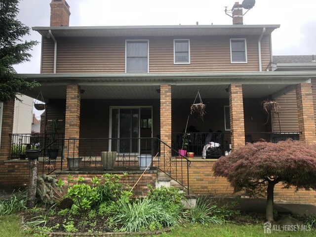 41 Bartha Ave, Edison, NJ 08817 - view of front of property with a porch and a chimney