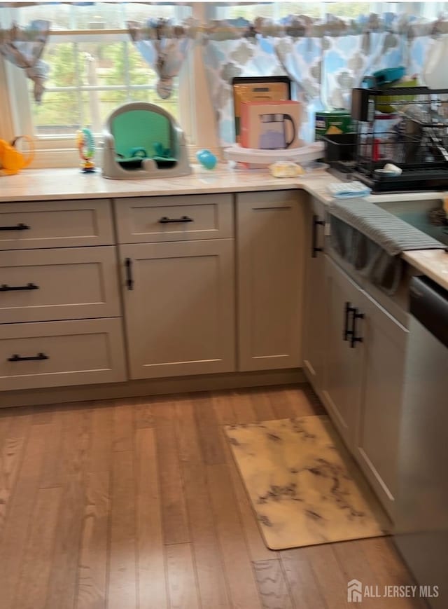 150 School St, Piscataway, NJ 08878 - kitchen with stainless steel dishwasher, light wood-type flooring, and light countertops