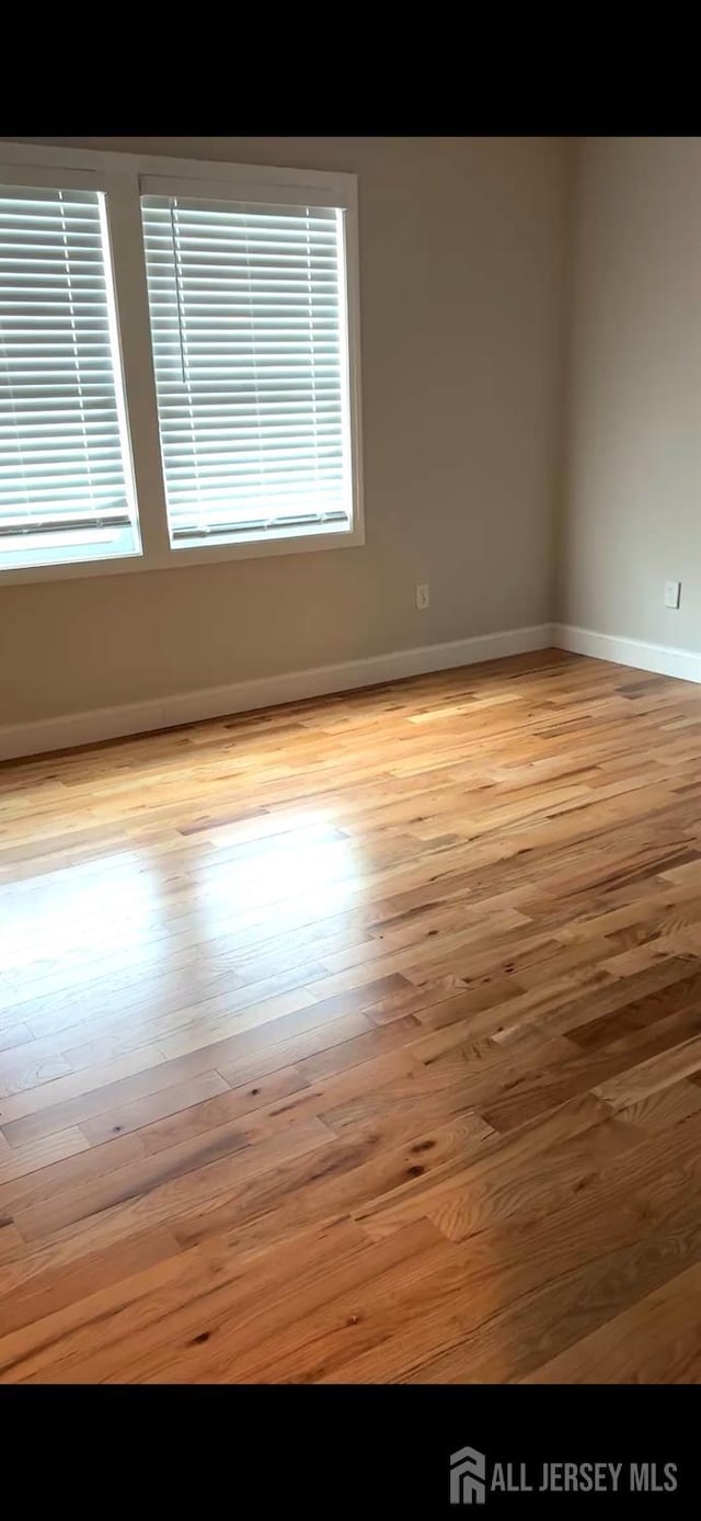 150 School St, Piscataway, NJ 08878 - spare room featuring wood finished floors and baseboards