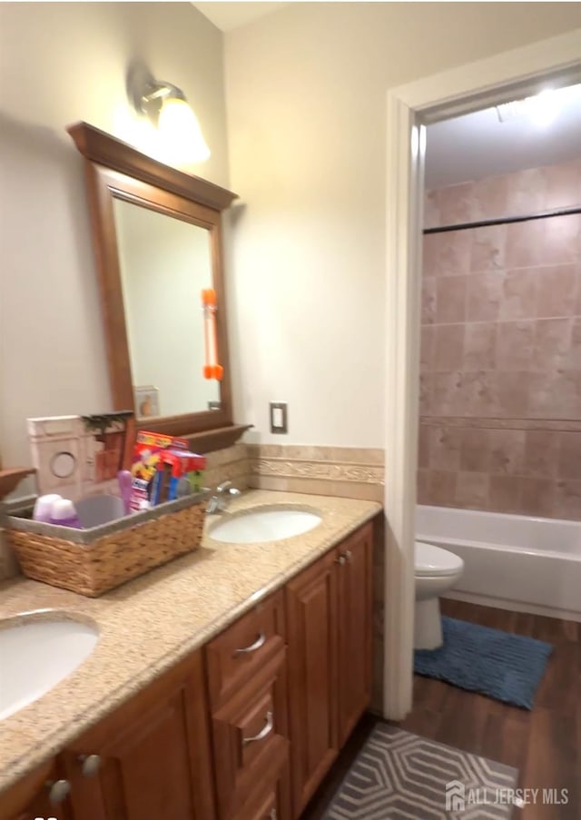 150 School St, Piscataway, NJ 08878 - bathroom featuring toilet, wood finished floors, double vanity, and shower / bath combination