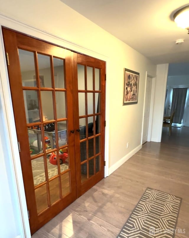 150 School St, Piscataway, NJ 08878 - entryway with french doors, wood finished floors, and baseboards