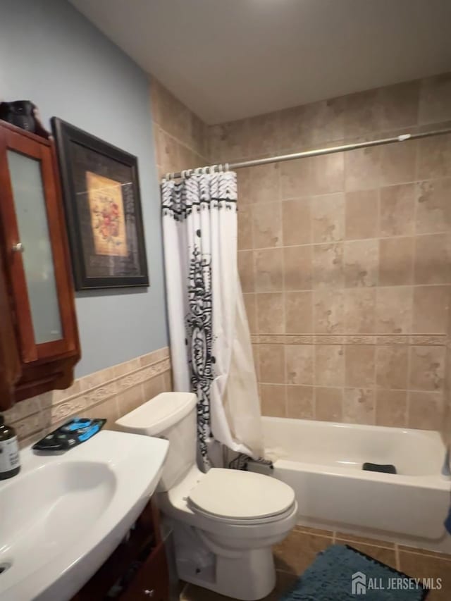 150 School St, Piscataway, NJ 08878 - bathroom featuring toilet, shower / bath combo with shower curtain, tile walls, and vanity