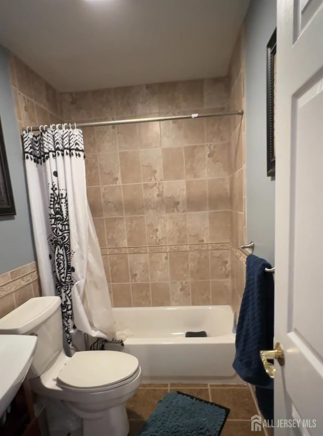 150 School St, Piscataway, NJ 08878 - bathroom featuring toilet, shower / tub combo with curtain, tile patterned floors, and tile walls