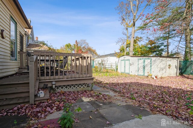 view of yard with a storage unit and a wooden deck