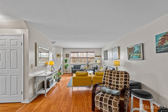 living area featuring wood finished floors and baseboards