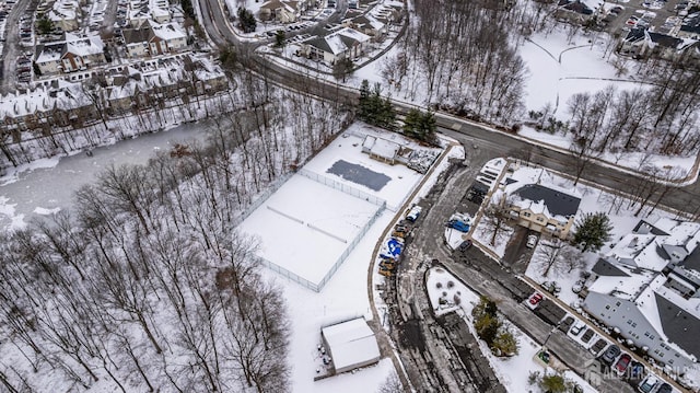 snowy aerial view featuring a residential view