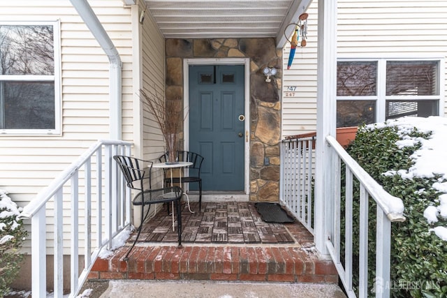 doorway to property featuring stone siding