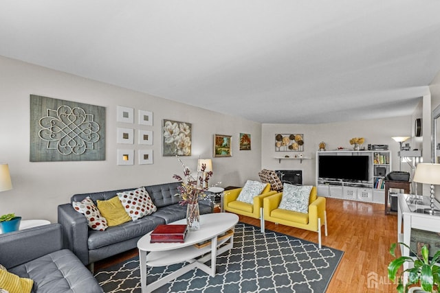 living area featuring a fireplace and wood finished floors