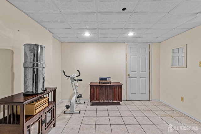 workout area featuring recessed lighting, baseboards, and light tile patterned floors