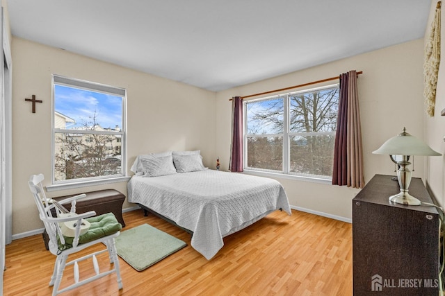 bedroom with baseboards and wood finished floors