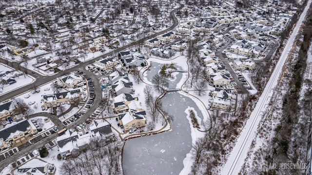 snowy aerial view with a residential view