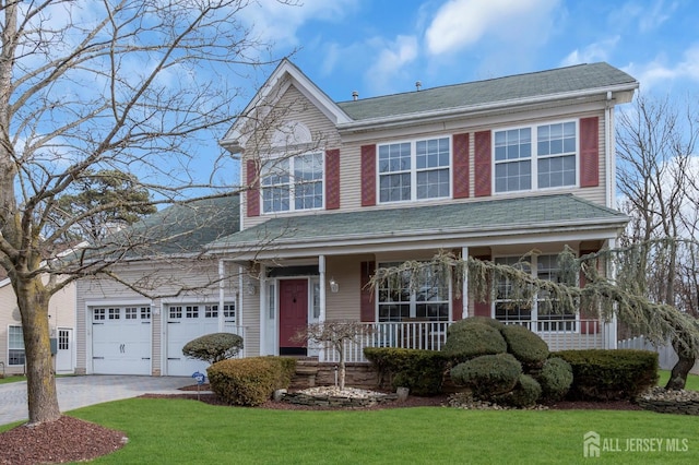 view of front of home with aphalt driveway, a front yard, covered porch, and an attached garage