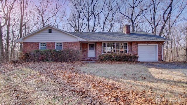 ranch-style house with brick siding, a chimney, and a garage