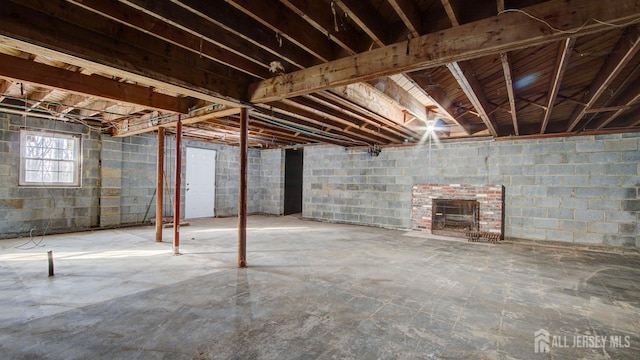 basement featuring a brick fireplace