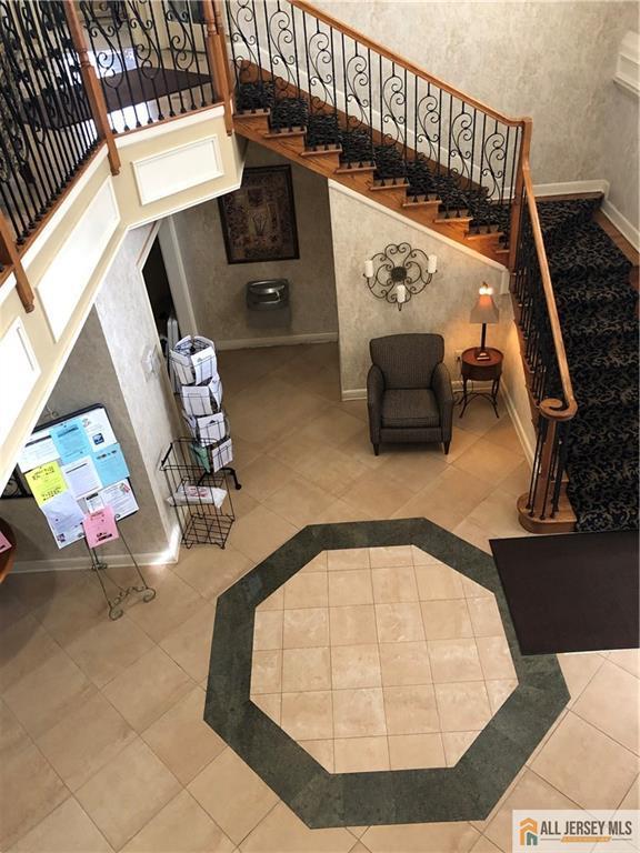 common area featuring stairs and a towering ceiling