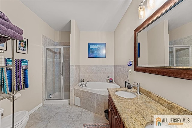 bathroom featuring a shower stall, a garden tub, double vanity, and toilet