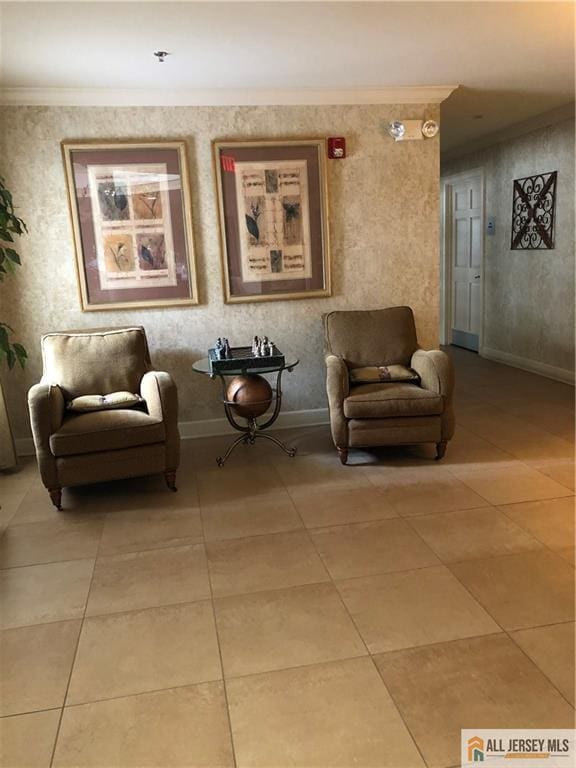 living area with baseboards, light tile patterned flooring, and crown molding