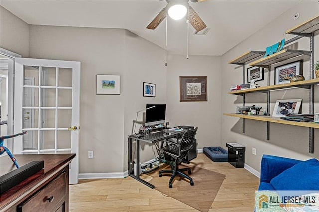 home office with light wood-style floors, a ceiling fan, and baseboards