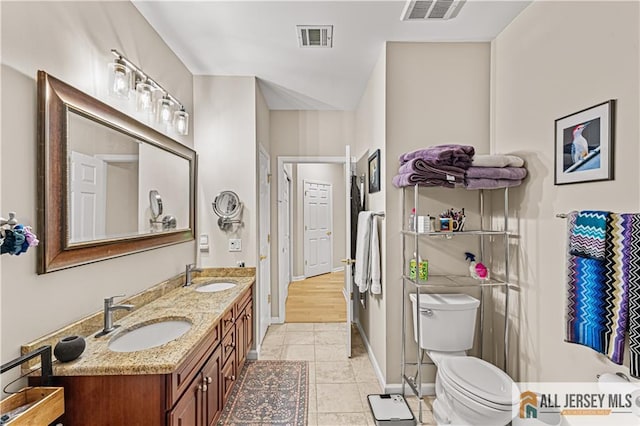 full bathroom with toilet, double vanity, tile patterned flooring, and baseboards