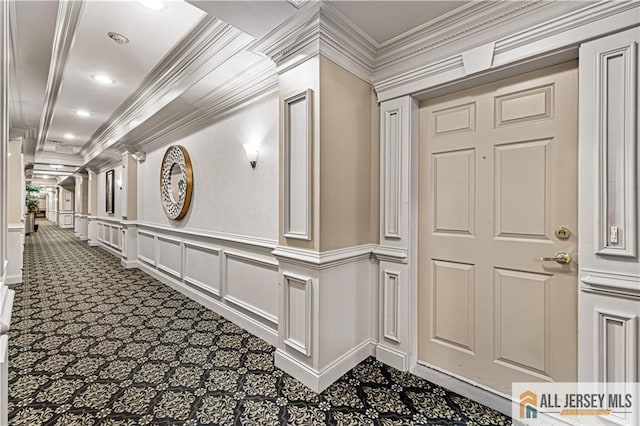 corridor with carpet flooring, crown molding, a decorative wall, and recessed lighting