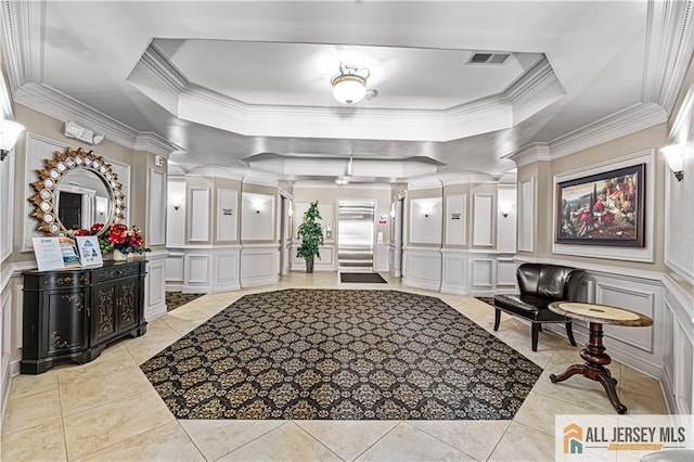 common area featuring a decorative wall and crown molding