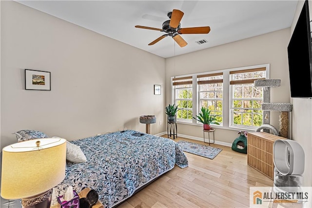 bedroom with wood finished floors, baseboards, and ceiling fan