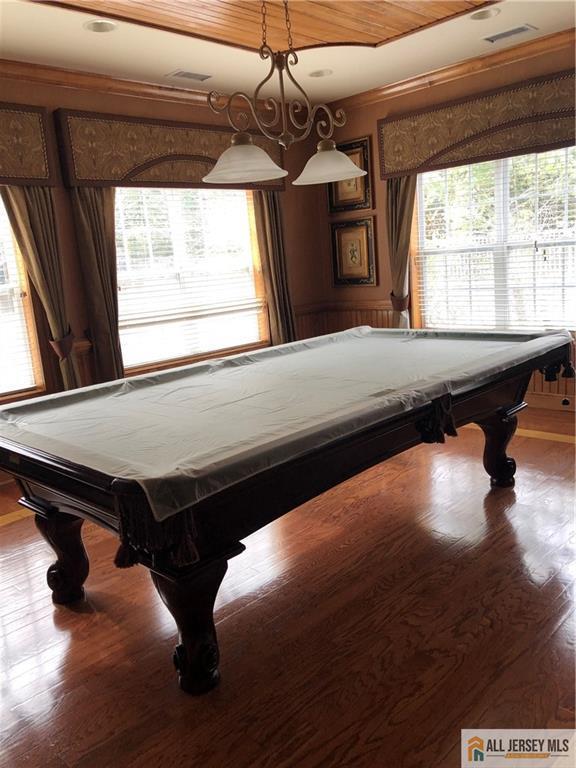 game room featuring billiards, ornamental molding, and wood finished floors