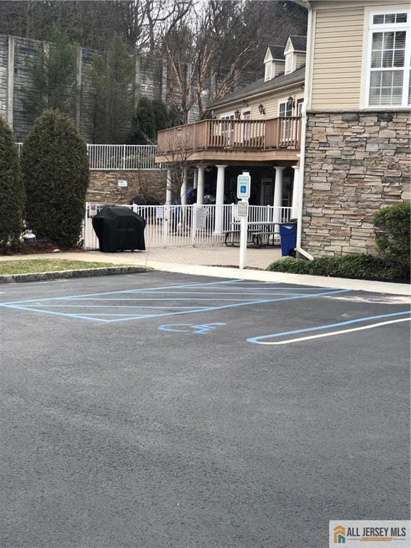 view of parking / parking lot featuring fence