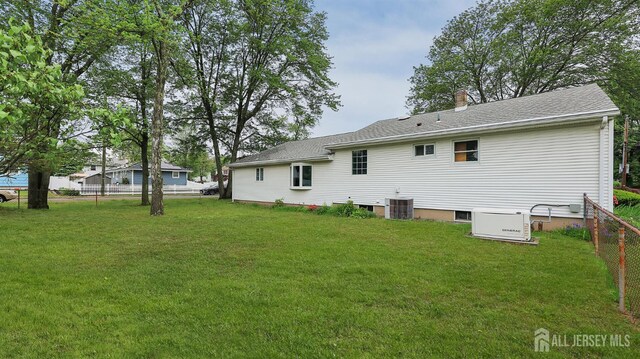 123 Summers Ave, Piscataway, NJ 08854 - back of house featuring central air condition unit, a shingled roof, and a chimney