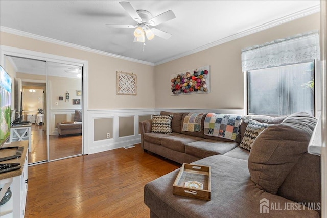 295 Gemini Dr Unit 3D, Hillsborough, NJ 08844 - living room featuring wood finished floors, ornamental molding, ceiling fan, and a wainscoted wall