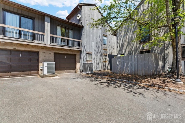 295 Gemini Dr Unit 3D, Hillsborough, NJ 08844 - view of property with central AC, asphalt driveway, and an attached garage