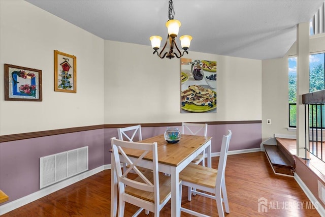 295 Gemini Dr Unit 3D, Hillsborough, NJ 08844 - dining room with a chandelier, wood finished floors, and baseboards