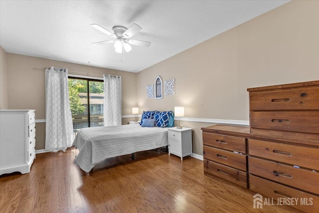 295 Gemini Dr Unit 3D, Hillsborough, NJ 08844 - bedroom with wood finished floors, access to exterior, baseboards, ceiling fan, and a textured ceiling