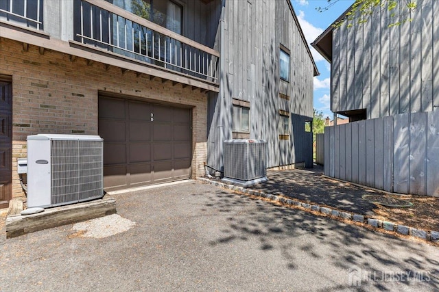 295 Gemini Dr Unit 3D, Hillsborough, NJ 08844 - view of home's exterior featuring cooling unit, an attached garage, brick siding, and a balcony