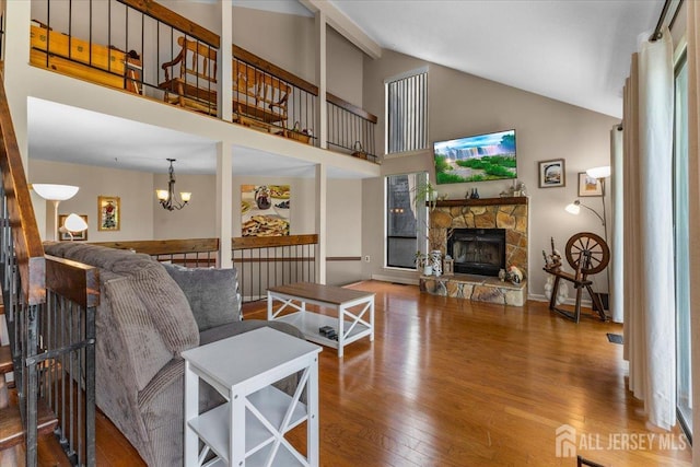 295 Gemini Dr Unit 3D, Hillsborough, NJ 08844 - living area with a fireplace, wood finished floors, high vaulted ceiling, a chandelier, and beamed ceiling