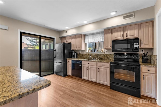 295 Gemini Dr Unit 3D, Hillsborough, NJ 08844 - kitchen featuring black appliances, light wood finished floors, recessed lighting, light stone countertops, and a sink