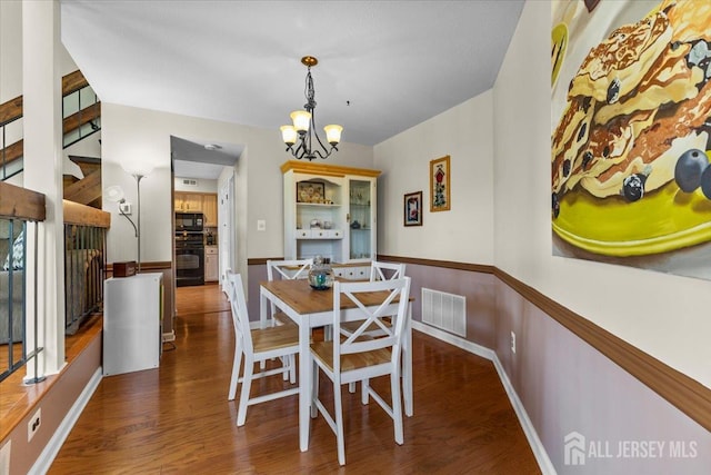 295 Gemini Dr Unit 3D, Hillsborough, NJ 08844 - dining area with a chandelier, wood finished floors, baseboards, and stairway