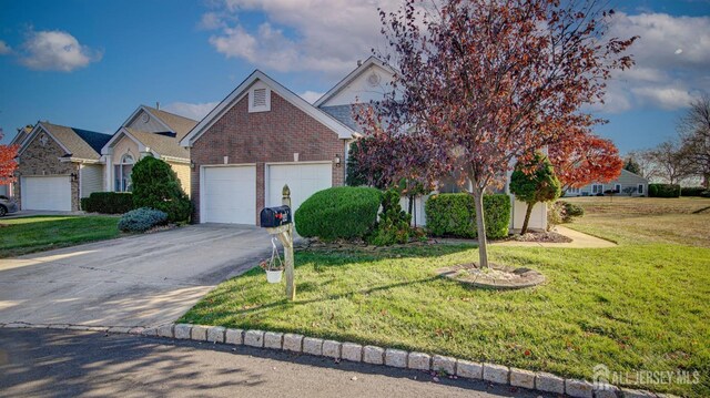 obstructed view of property with a front yard and a garage