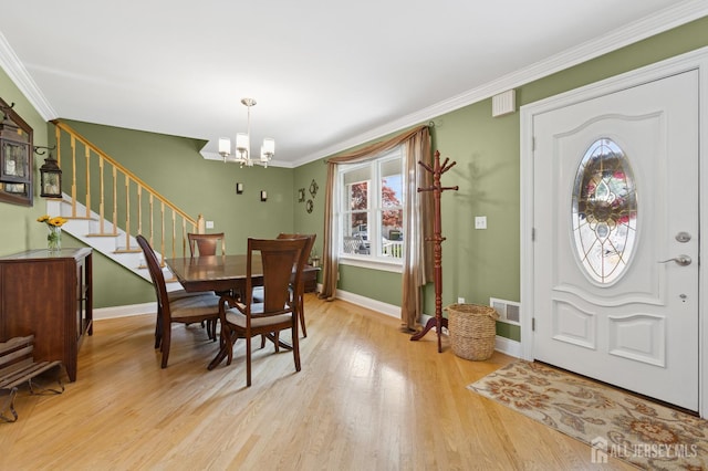 3223 Banta Rd, South Plainfield, NJ 07080 - dining room featuring a chandelier, stairs, light wood-style floors, baseboards, and crown molding
