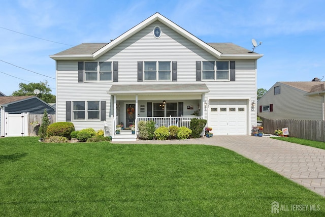 3223 Banta Rd, South Plainfield, NJ 07080 - traditional home featuring a porch, decorative driveway, an attached garage, and a gate