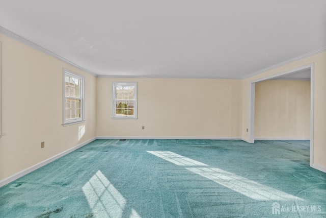 carpeted empty room with crown molding and baseboards