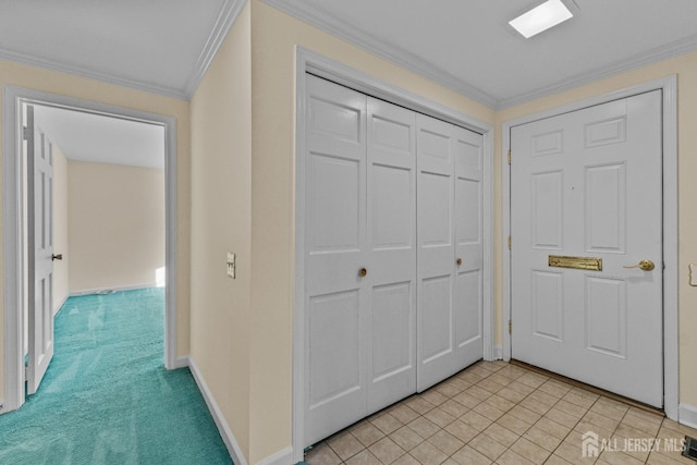 hall featuring baseboards, light carpet, and crown molding