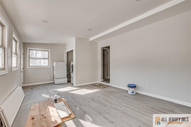 40 Brown Ave, Iselin, NJ 08830 - unfurnished living room featuring washing machine and dryer and baseboards